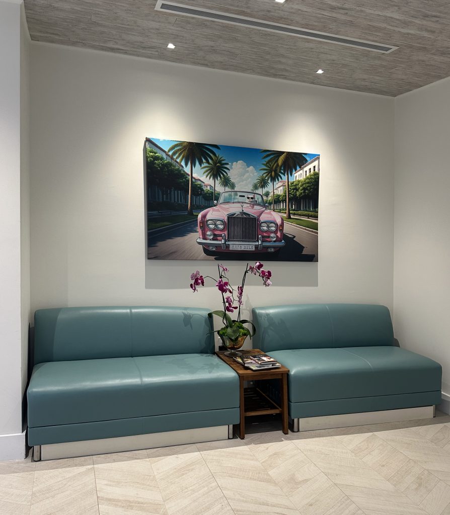 A stylish and welcoming waiting room featuring modern seating and vibrant artwork. Soft teal benches provide comfortable seating