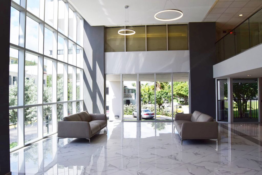 lobby with marble floors, grey leather sofa from Roche Bobois